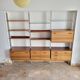 Large Scandinavian wall-mounted wood and aluminum bookcase circa 1960