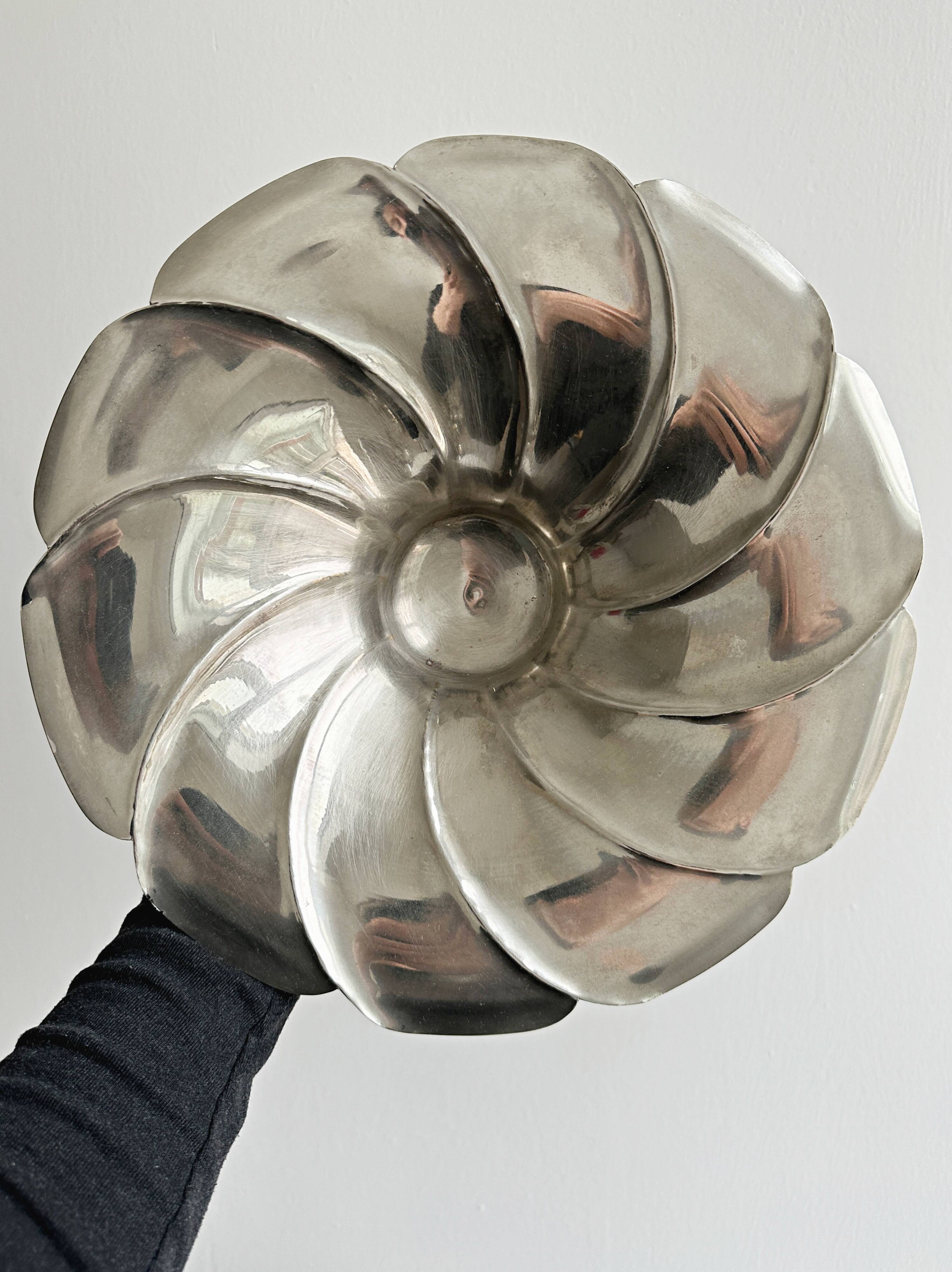 large dish on a shiny metal stand