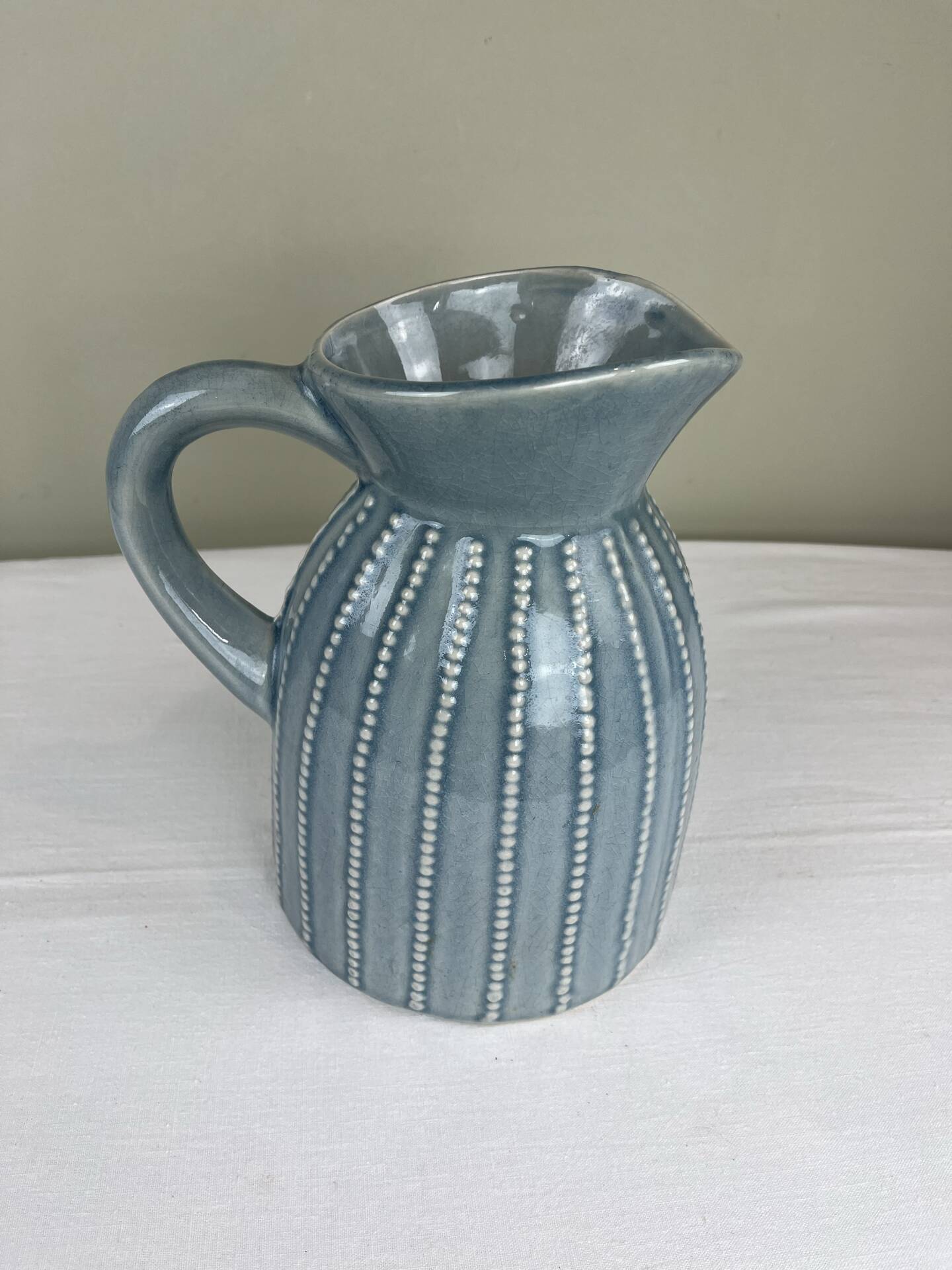 Large vintage pitcher in crackled celadon ceramic, beaded decoration.