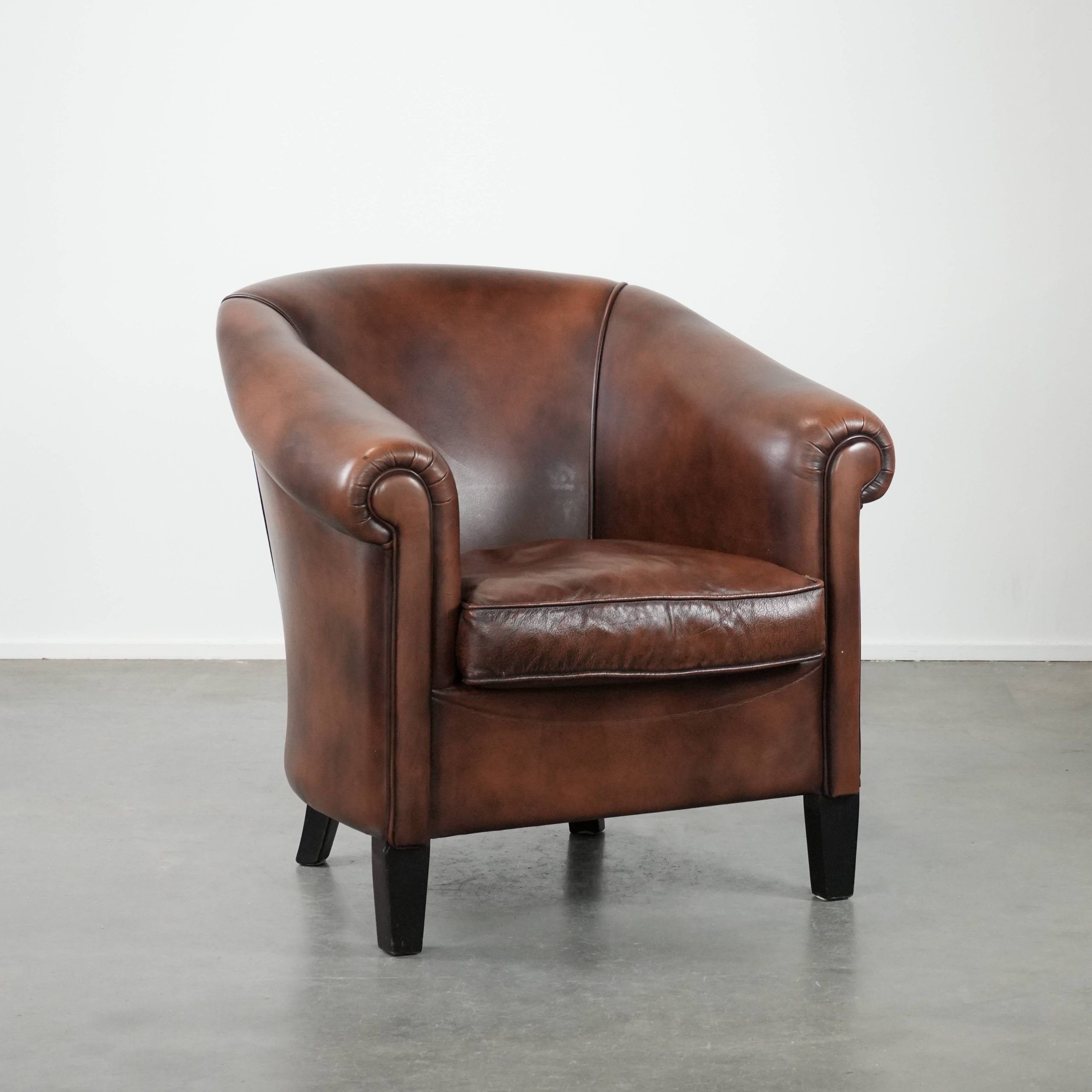 Great luxurious brown cowhide club armchair with matching piping