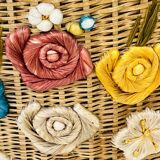Vintage wicker mannequin with colourful floral decoration.