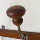 Old wooden and metal wall-mounted coat rack.