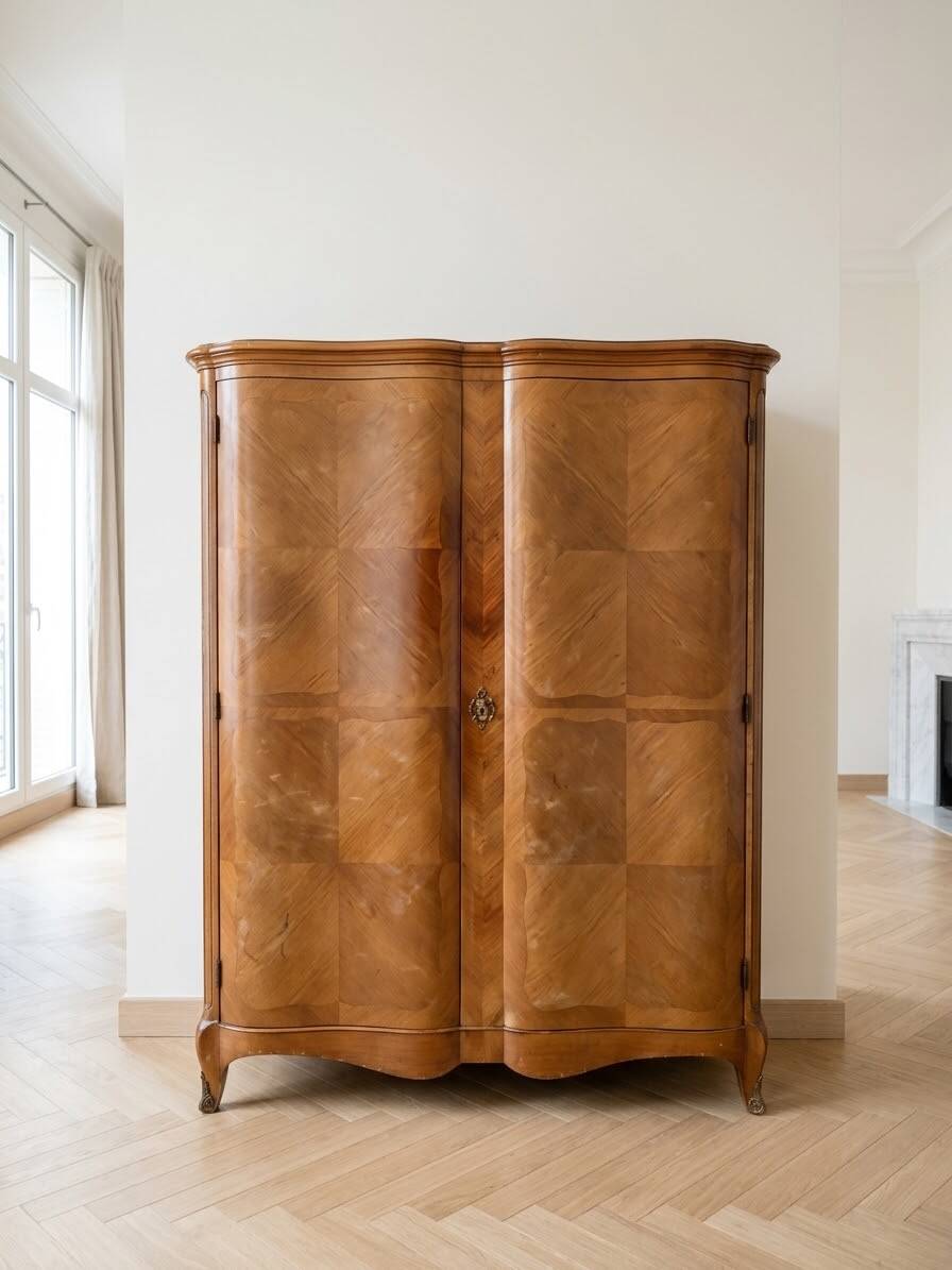 Antique Louis XV style wardrobe with curved wooden doors.