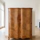 Antique Louis XV style wardrobe with curved wooden doors.