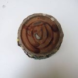 Old earthenware pot with ivy decoration.