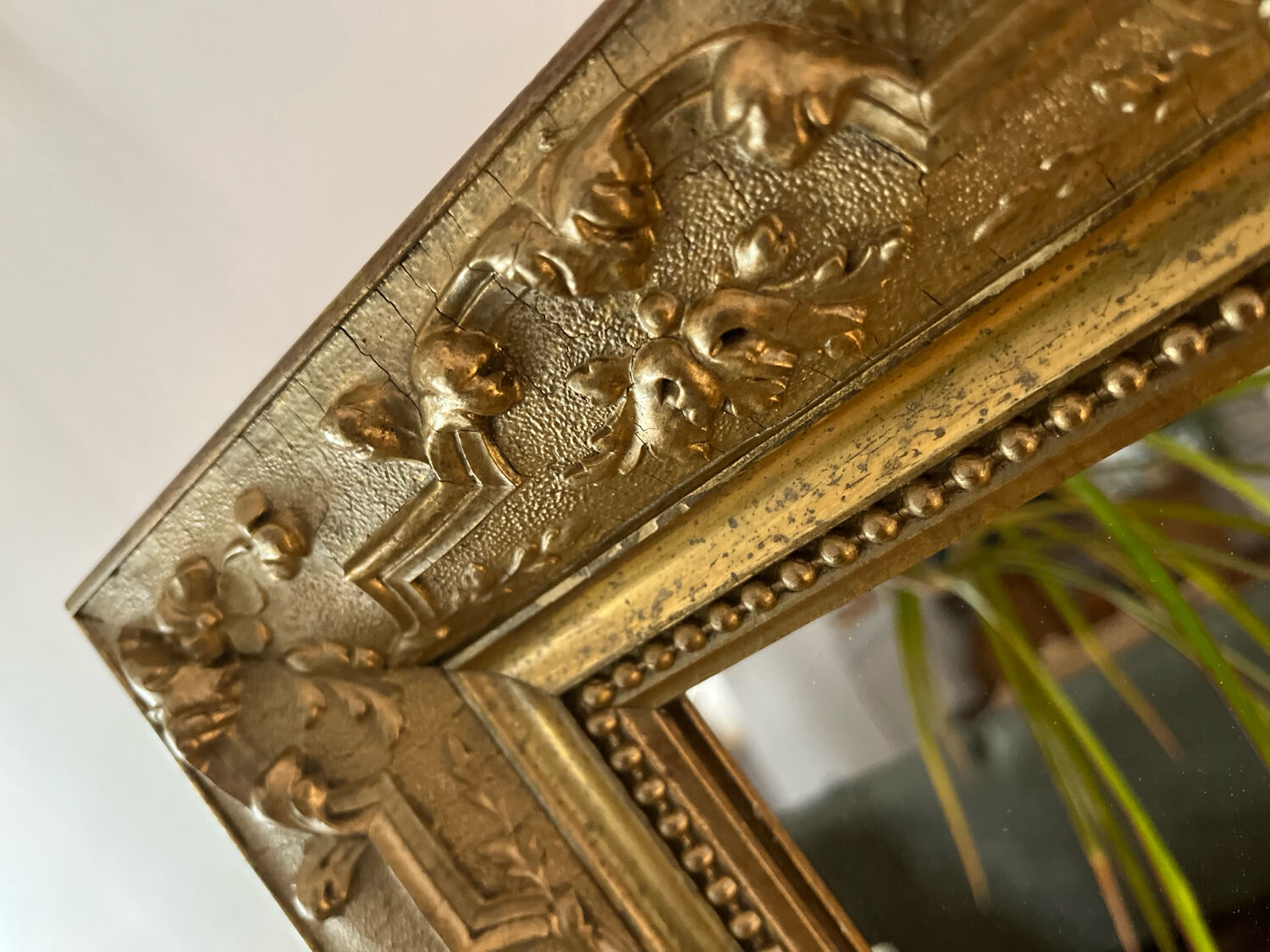 Gilded mirror with antique wood and stucco frame