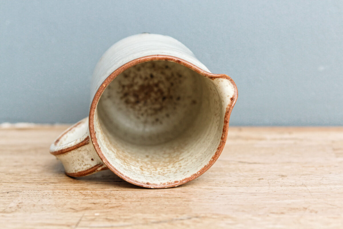 Enamelled sandstone milk jar, signed