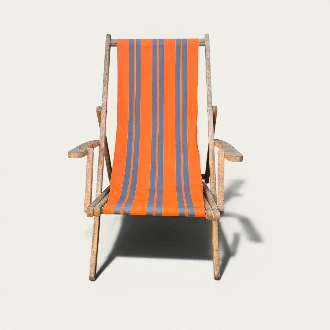 Vintage deck chair with orange and grey striped fabric, original patina.