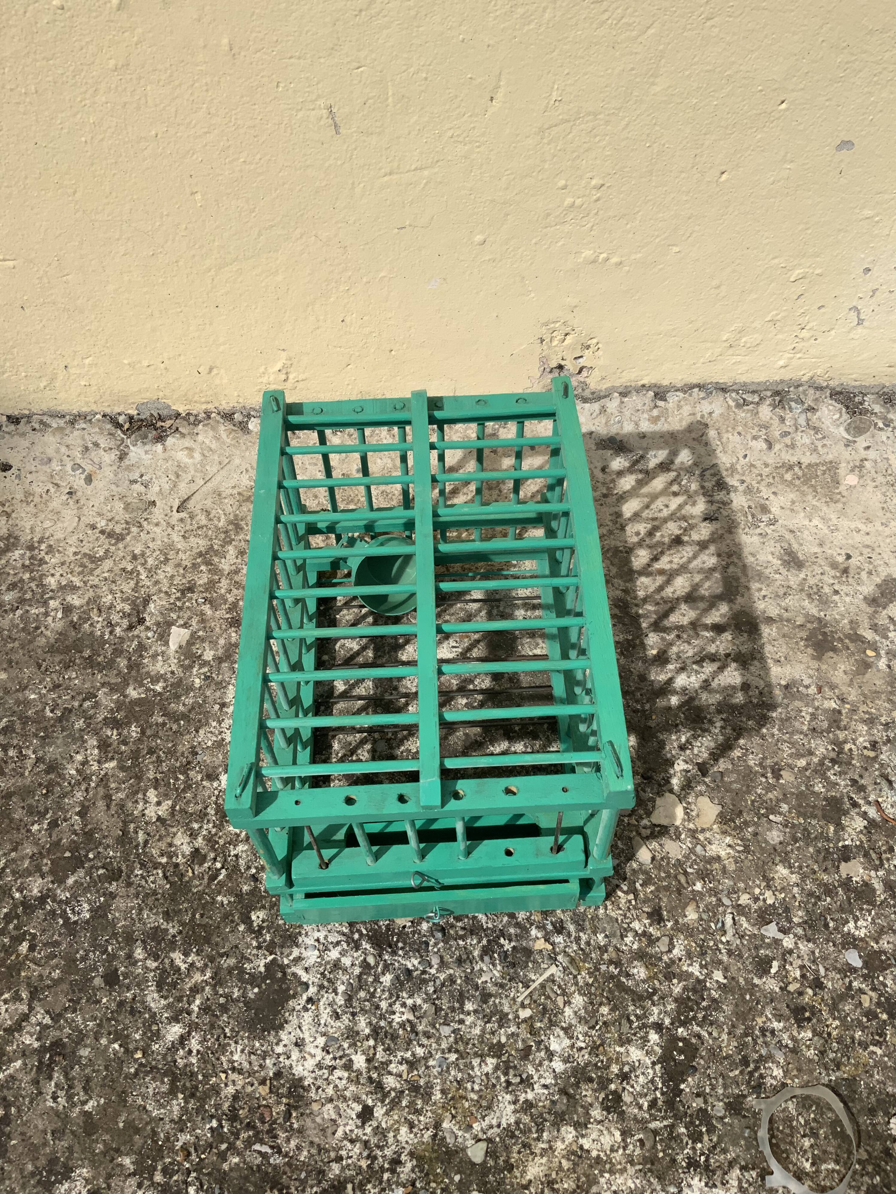 Vintage bird cage in green wood retro paint