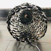 Black wrought iron lamp with a white glass globe.