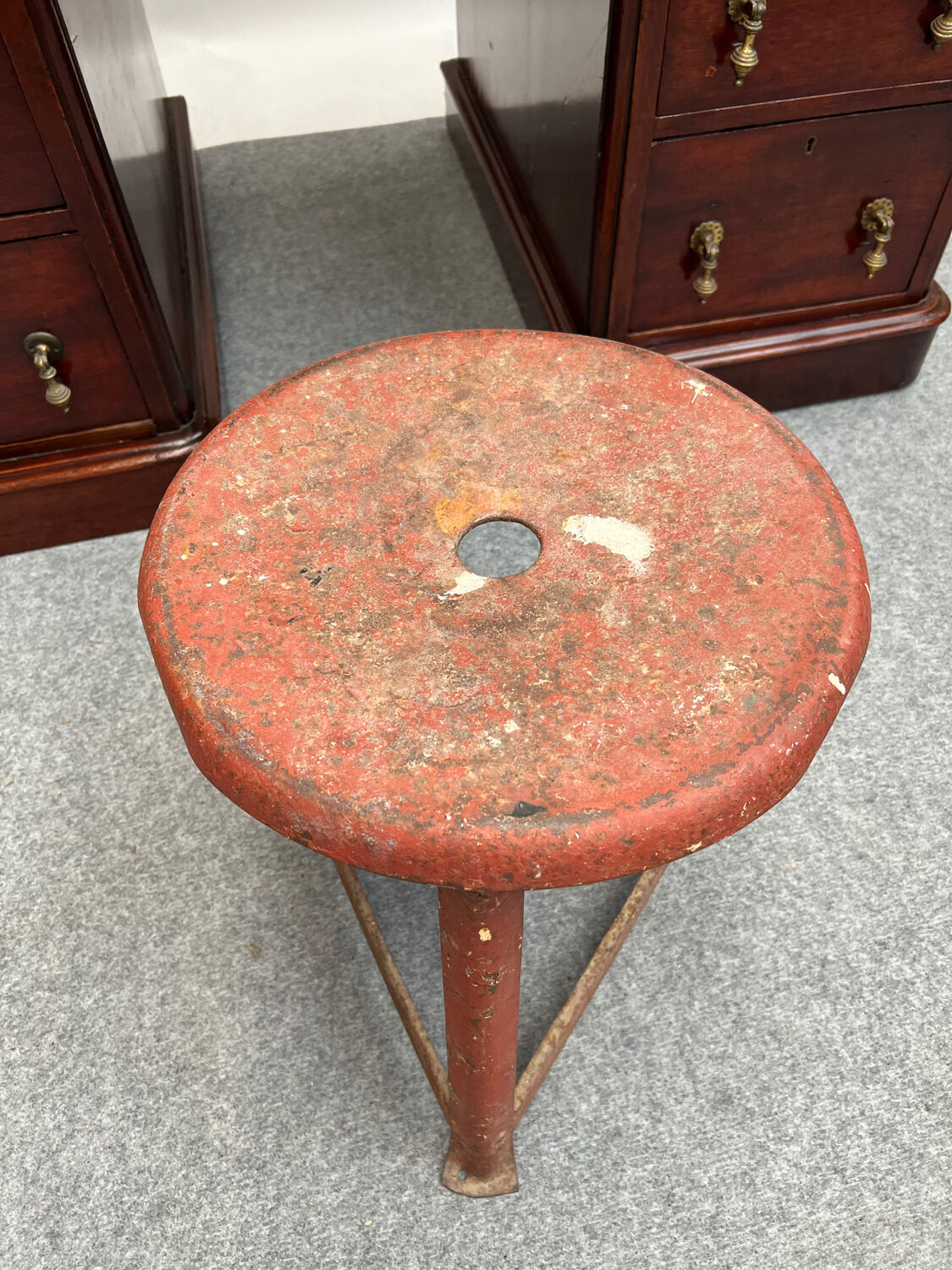 Red tripod industrial metal stool