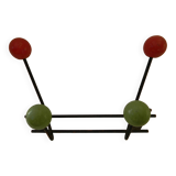 Small wrought iron coat rack with wooden balls.