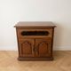 Rustic wooden TV unit with a swivel top and moulded doors.