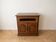 Rustic wooden TV unit with a swivel top and moulded doors.