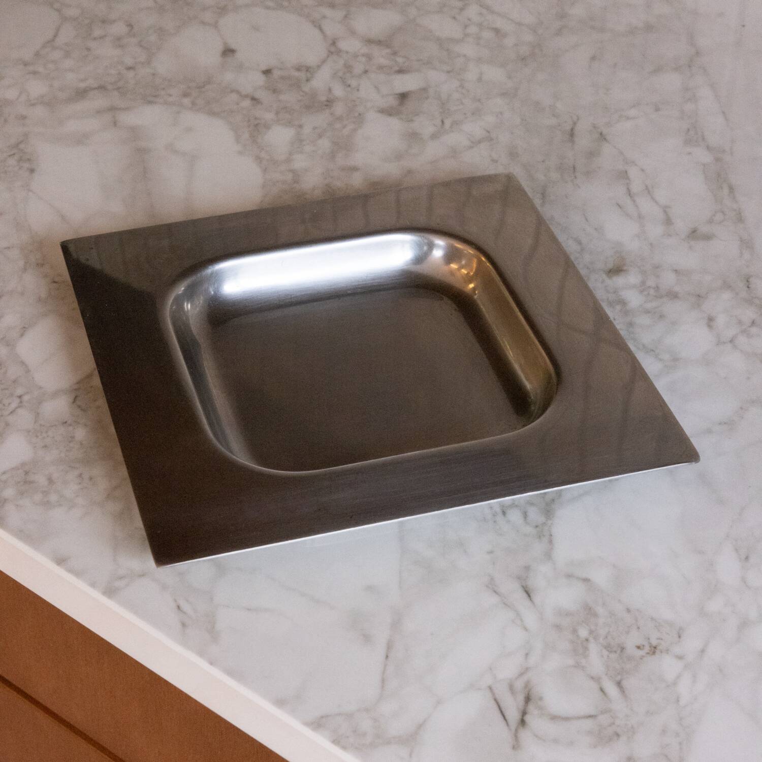 Minimalist stainless steel pocket emptier
