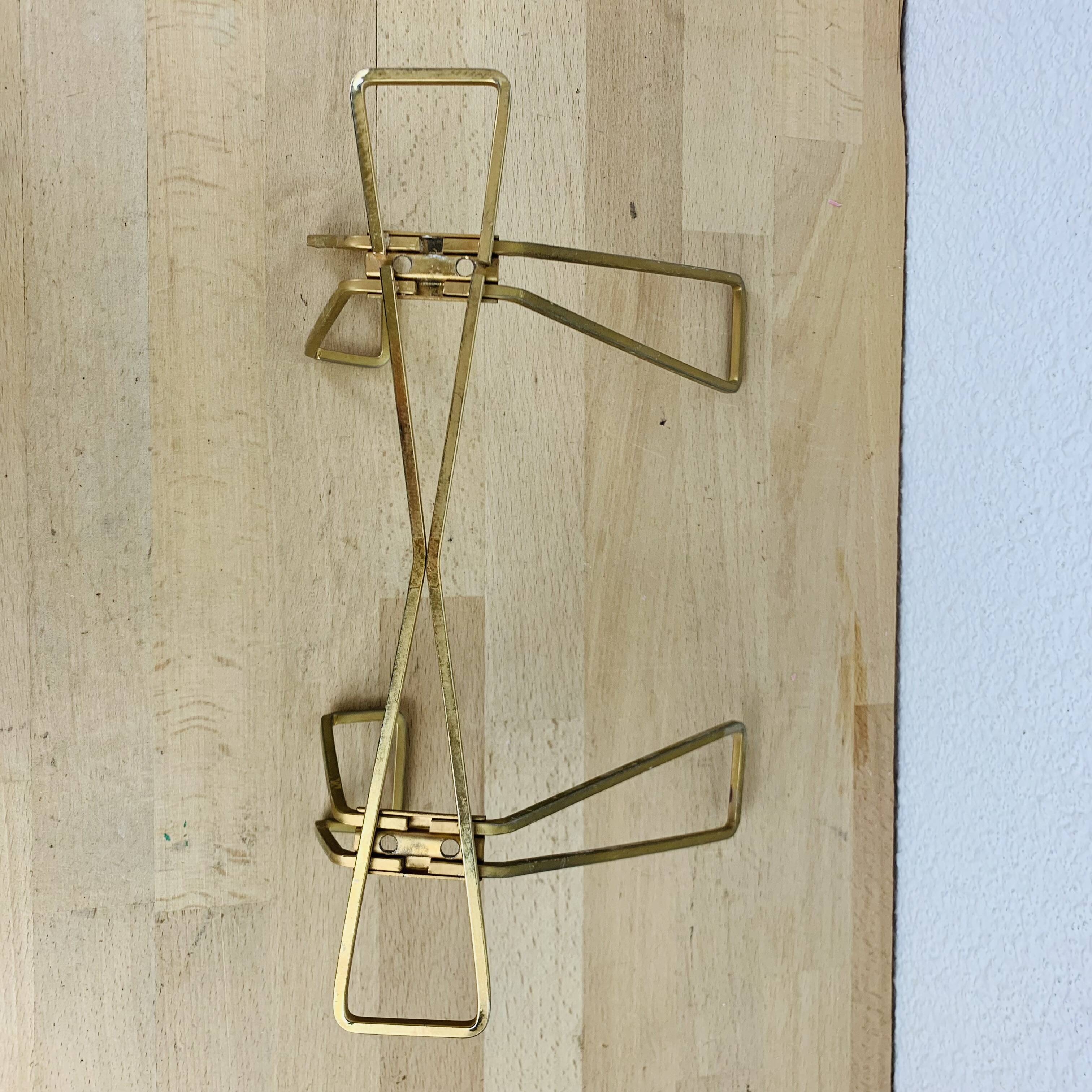 Wall coat rack with golden metal hook from the 1950s
