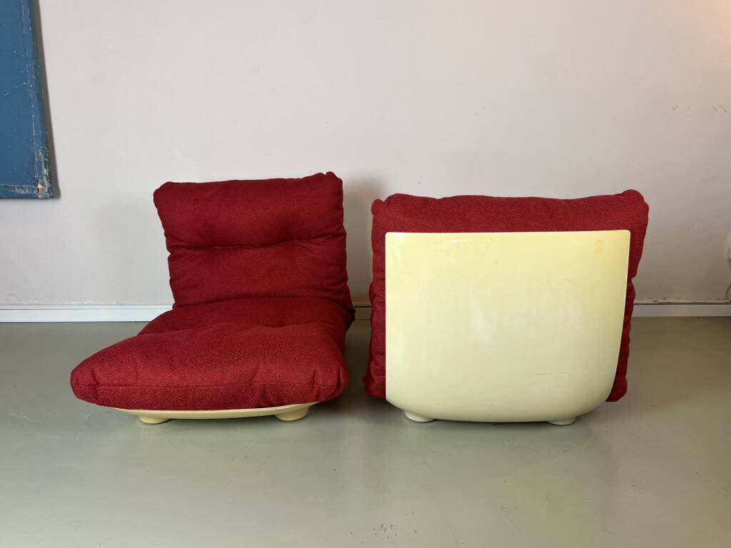 Vintage red shell lounge chairs from the 70s mid-century retro.
