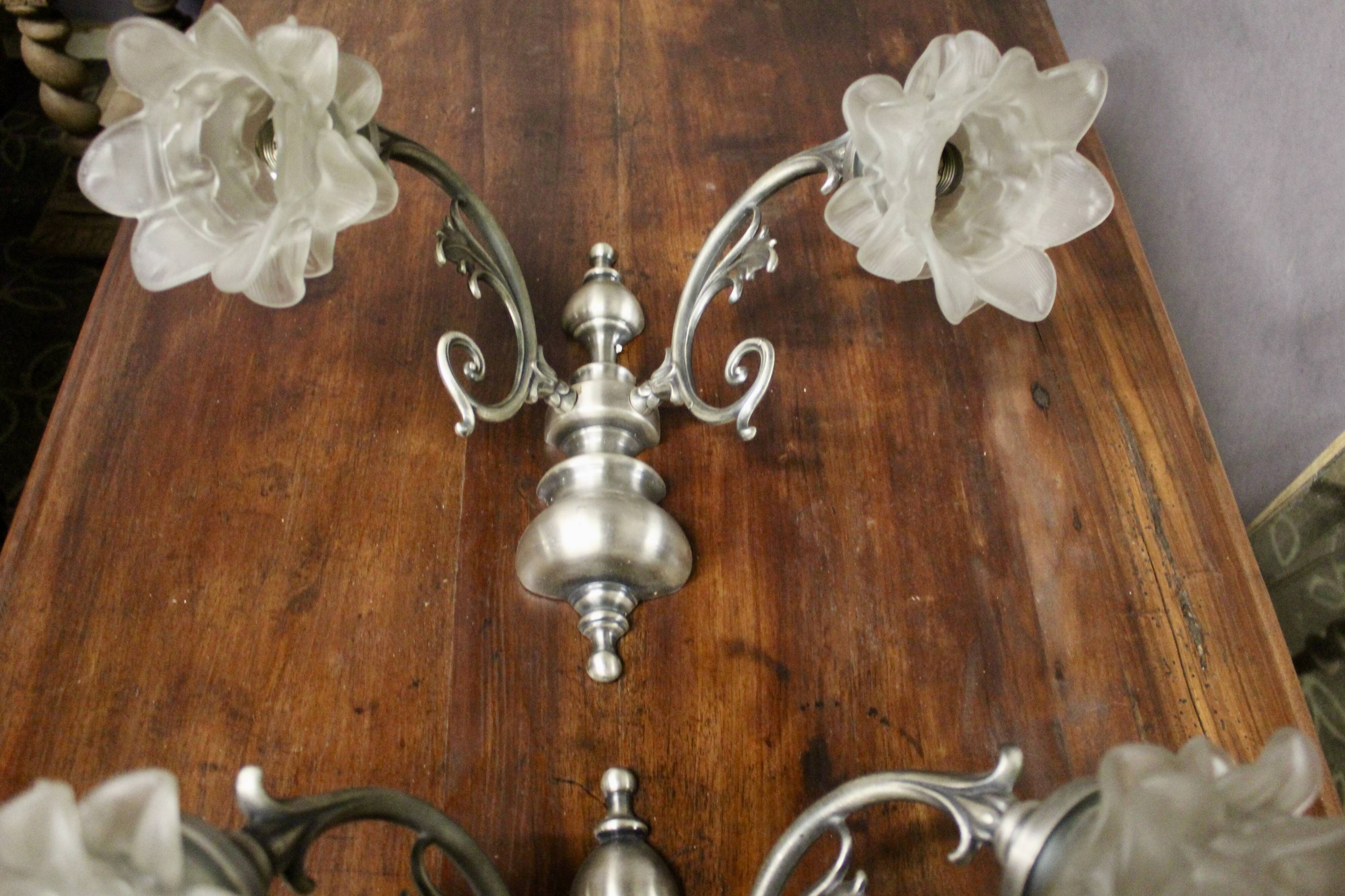 Pair of wall sconces with 2 light arms