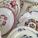 Set of 8 ironstone plates with coordinated designs.