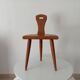 Low brutalist tripod chair in solid oak from the 1960s.