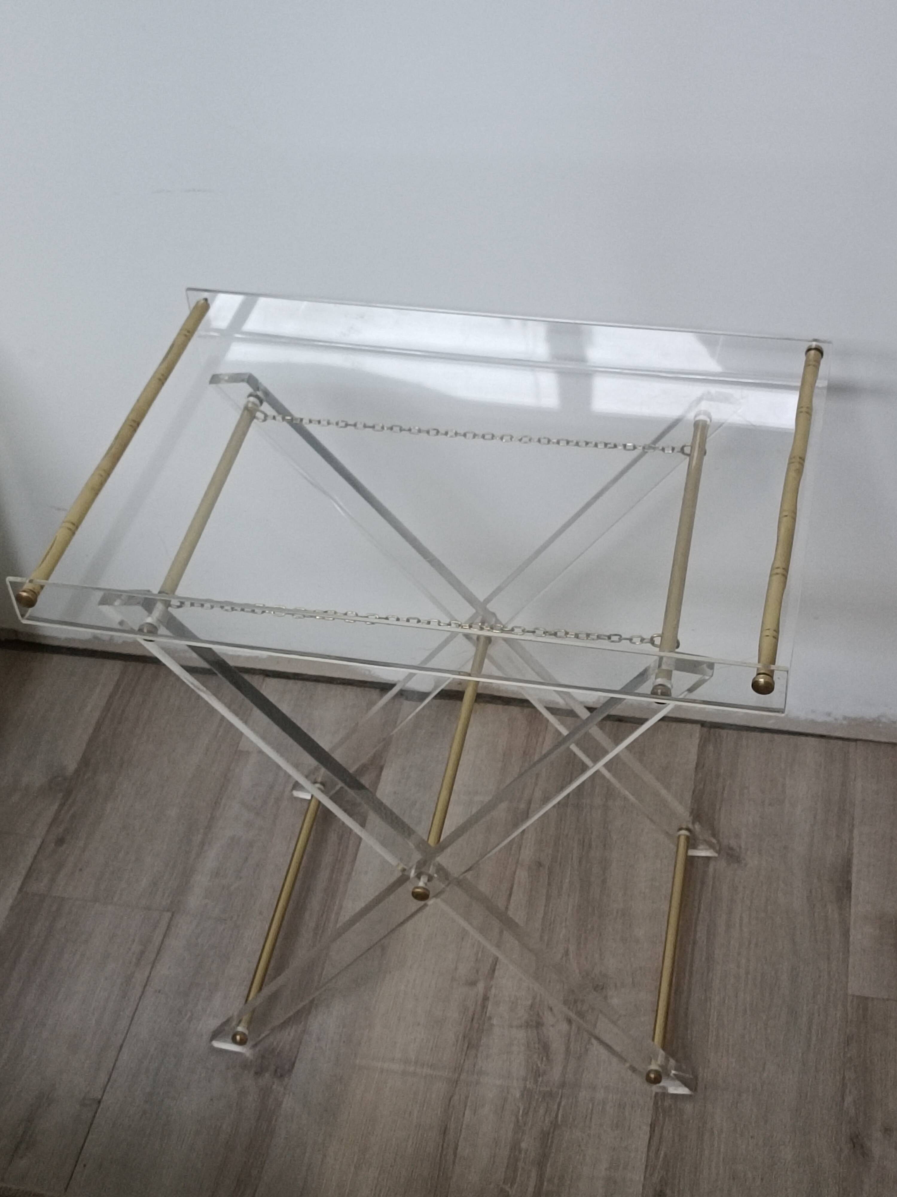 Folding side table in plexiglass and brass, 1970s.