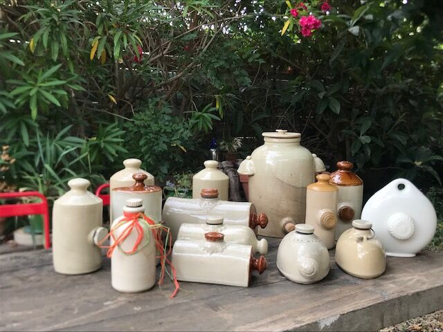 Old hot water bottle made of vintage white earthenware