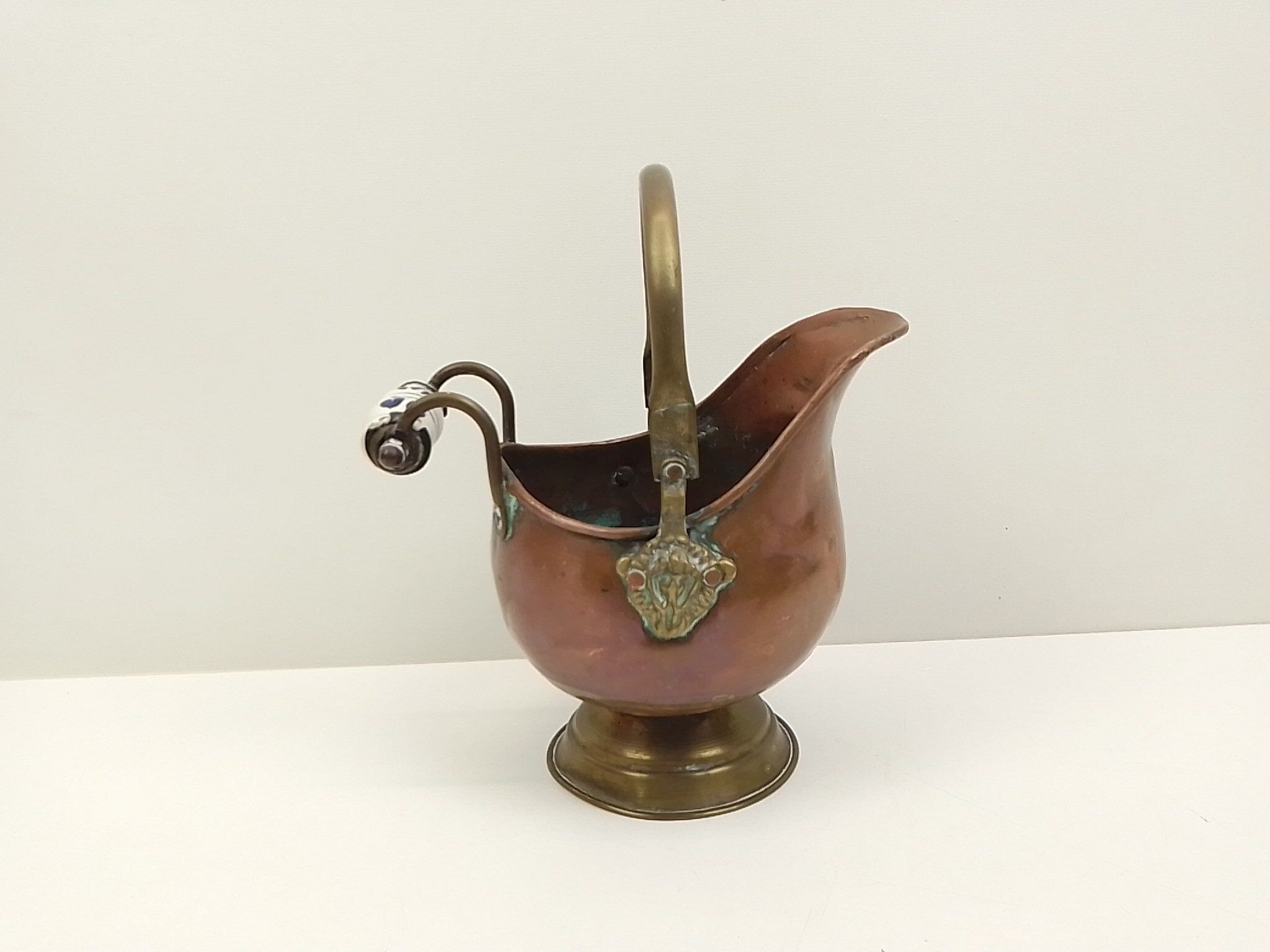Copper pot cover and a pitcher-style brass handle
