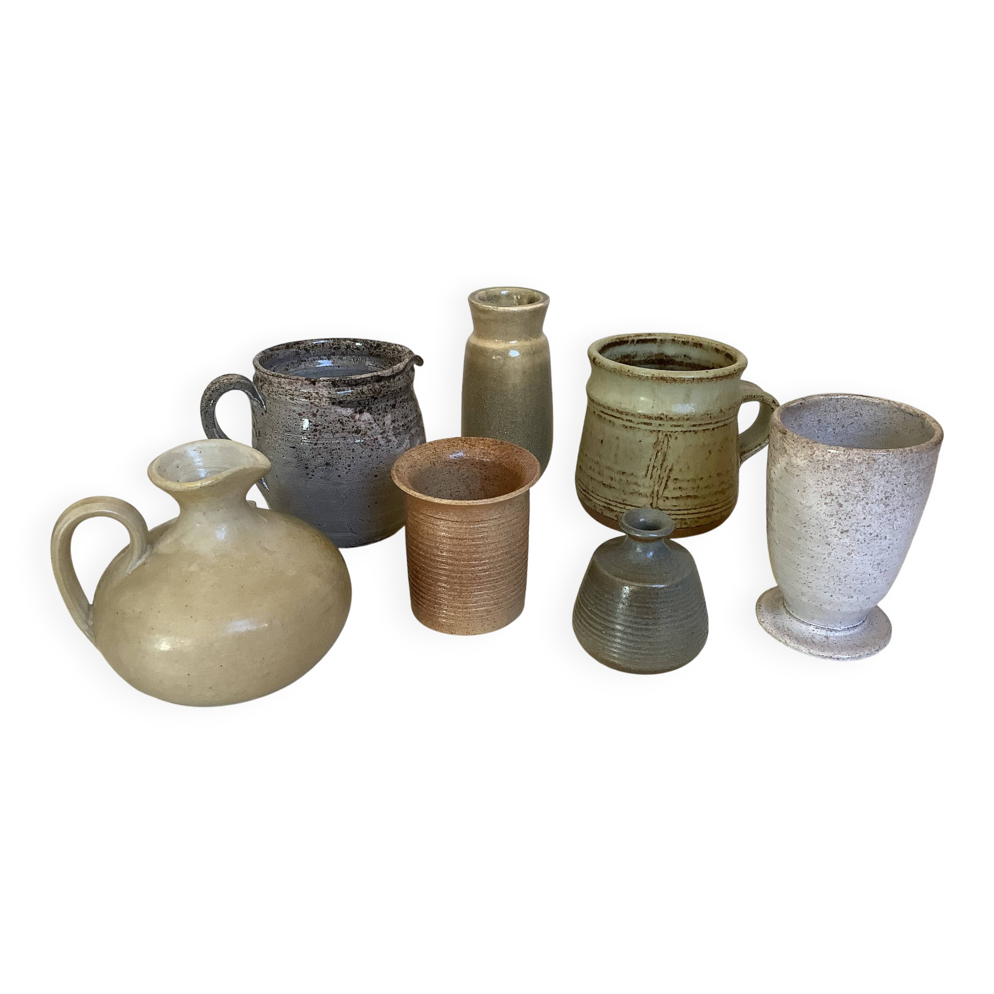 Seven beige and gray ceramic vases