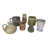 Seven beige and gray ceramic vases