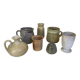 Seven beige and gray ceramic vases