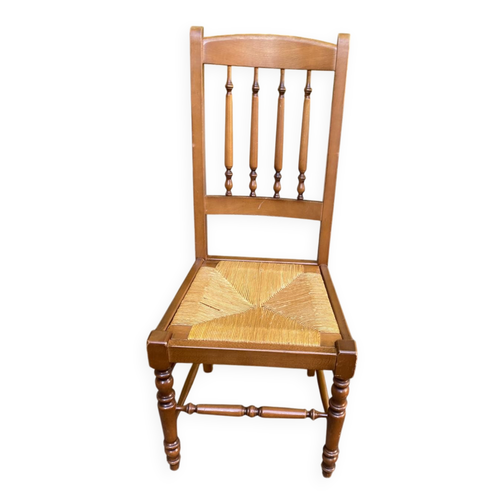 Solid wood chair with a straw seat and carved bar backrest.
