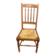 Solid wood chair with a straw seat and carved bar backrest.