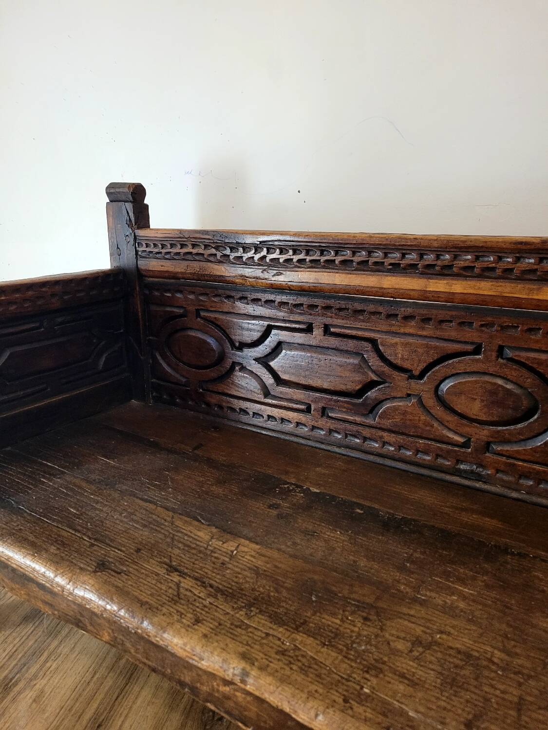 Antique carved solid wood bench from the early 20th century