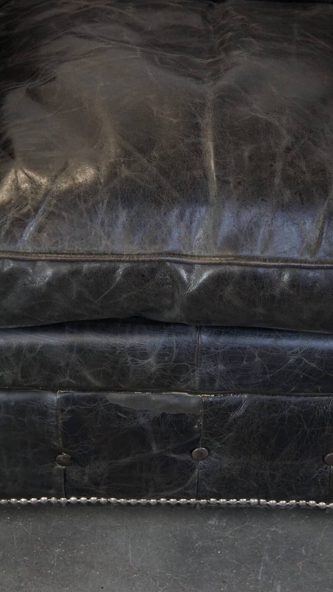 Spacious black cow leather chesterfield armchair with distinctive character