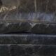 Spacious black cow leather chesterfield armchair with distinctive character