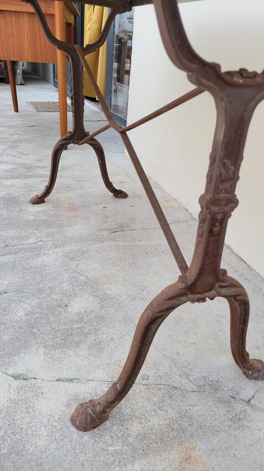 Restaurant bistro table in oval marble and decorated cast iron bases -1m51