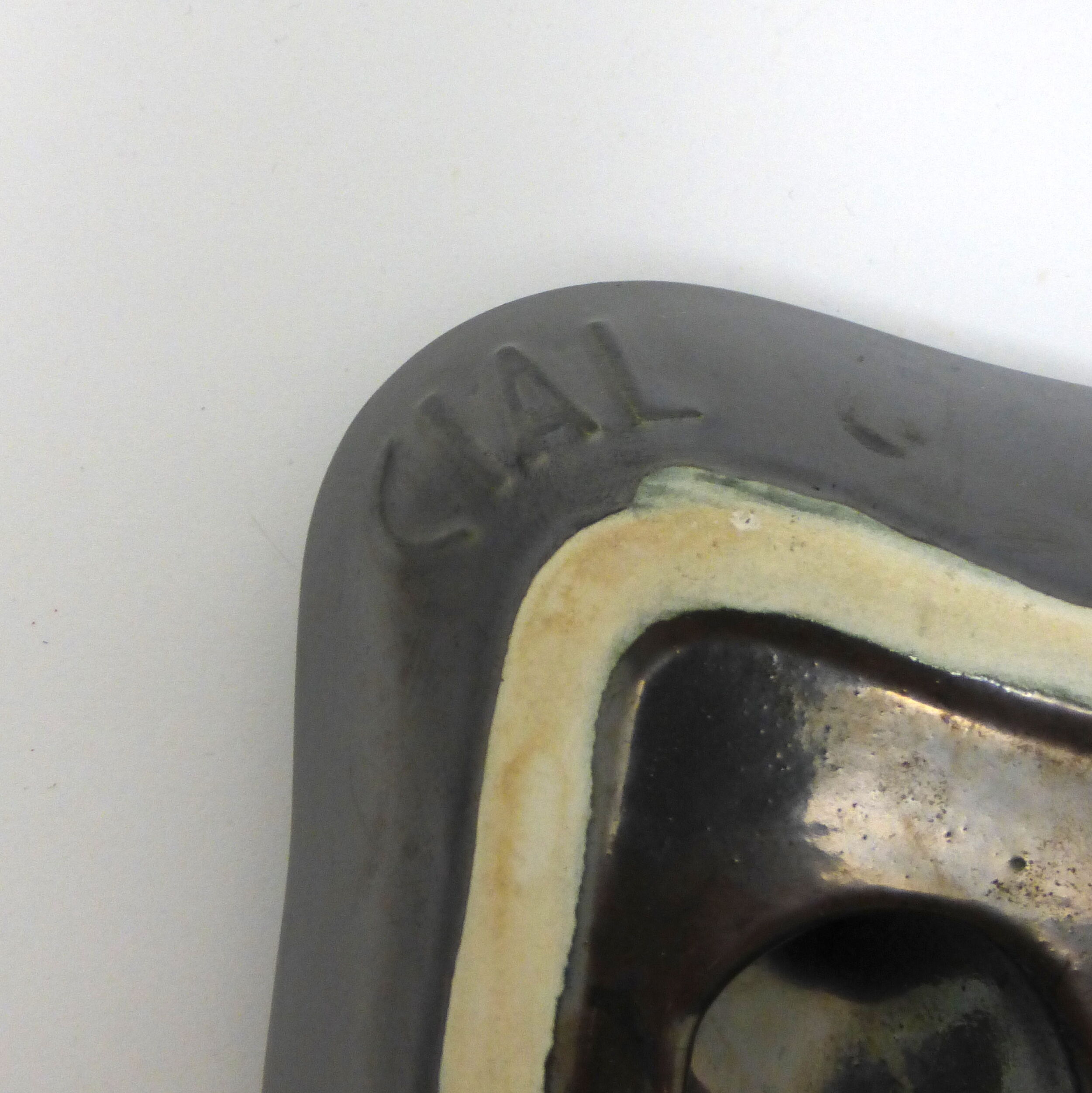 Ashtray in metallic black ceramic around 1950