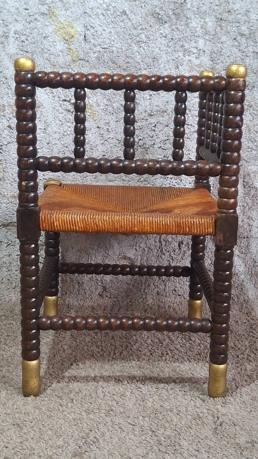 Fireplace corner chair in Louis XIII style, turned wood with braided rush, 19th century.