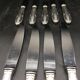 9 table knives in silver metal.