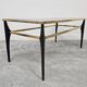Mid Century Modern coffee table with gold-plated metal and smoked glass.