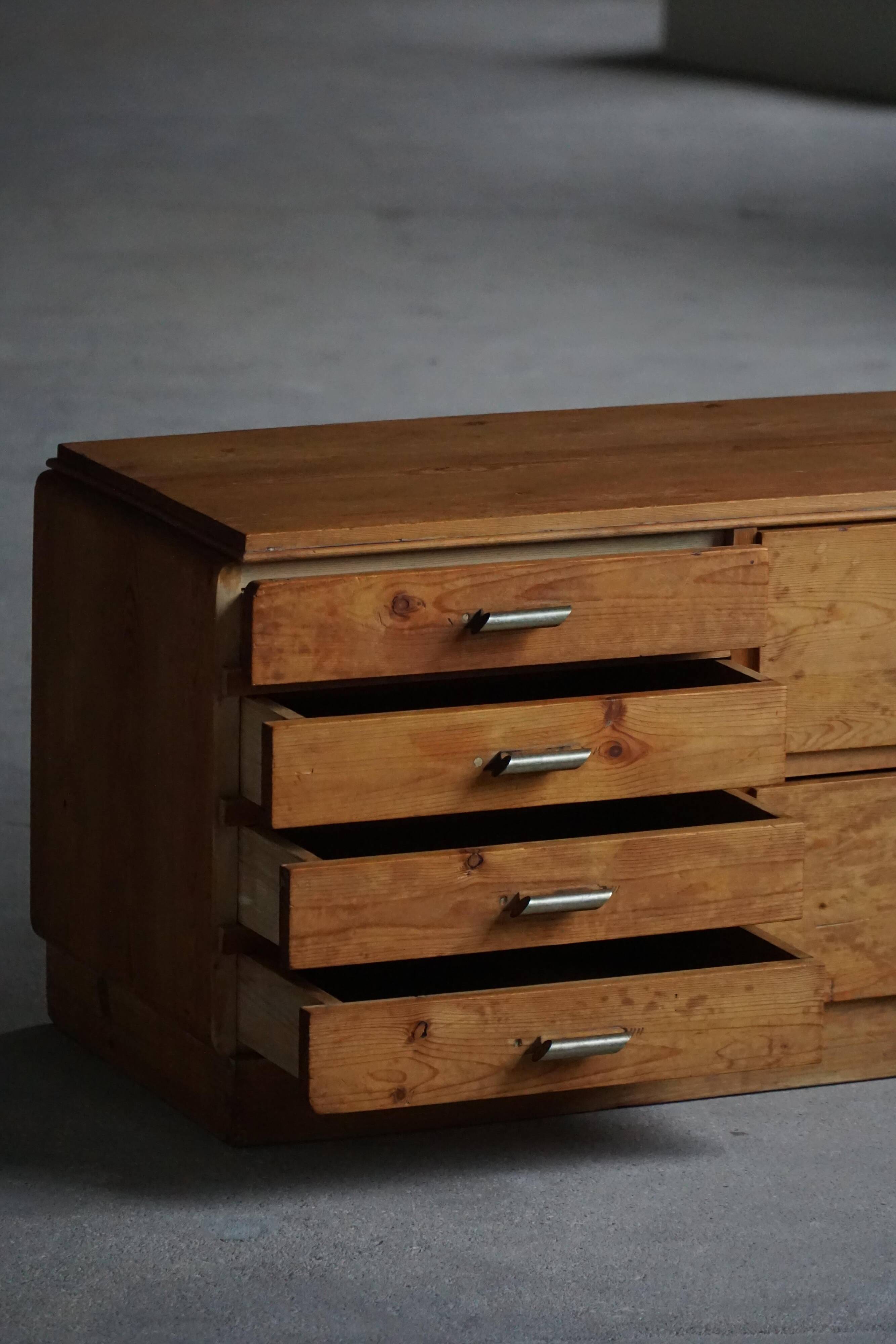 Mid-20th century Art Deco chest of drawers in pine with metal handles, 1940s.
