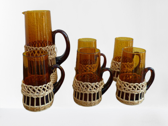 Fruit juice or vintage lemonade service in glass and wicker.