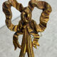 Bronze wall light, decorated with a bow and ribbon.