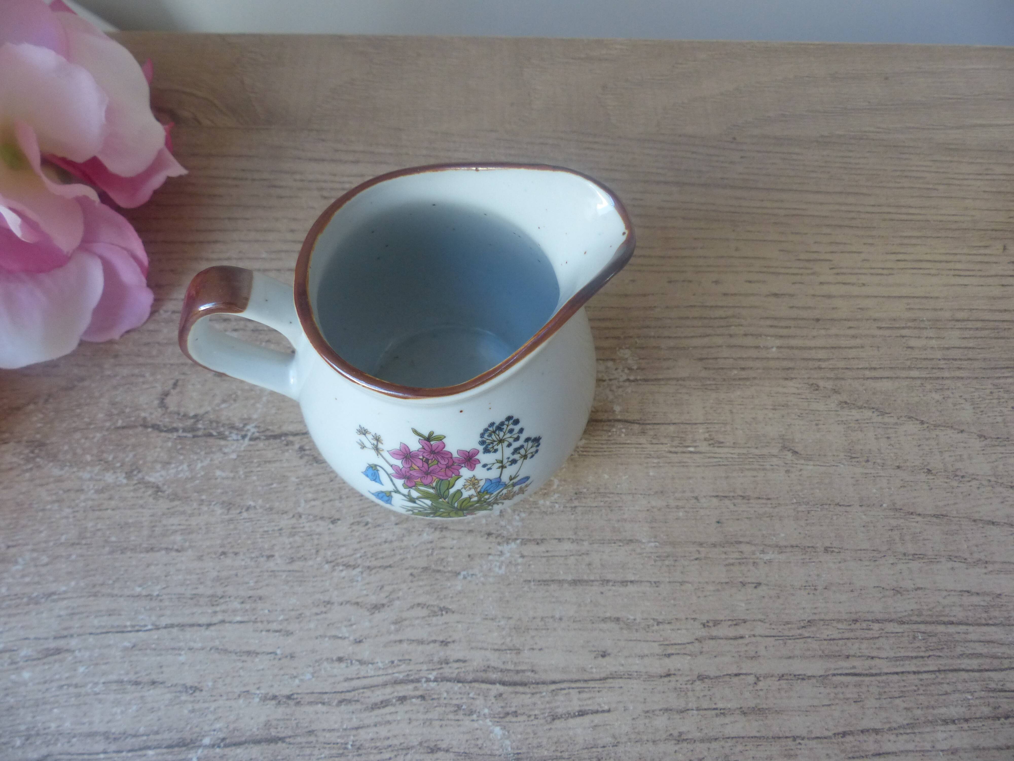 Old small artisanal milk jug in flowered speckled stoneware from the 1980s