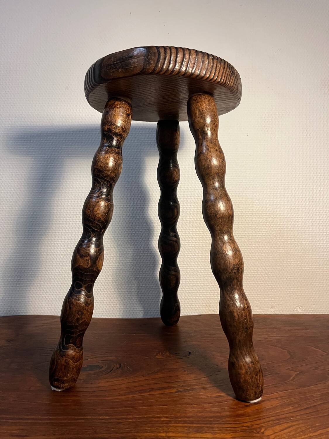 Round wooden tripod stool