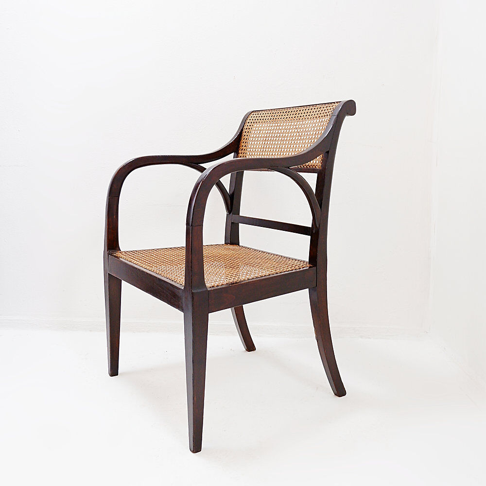 Mid-century curved wooden chairs with cane seats and backs.