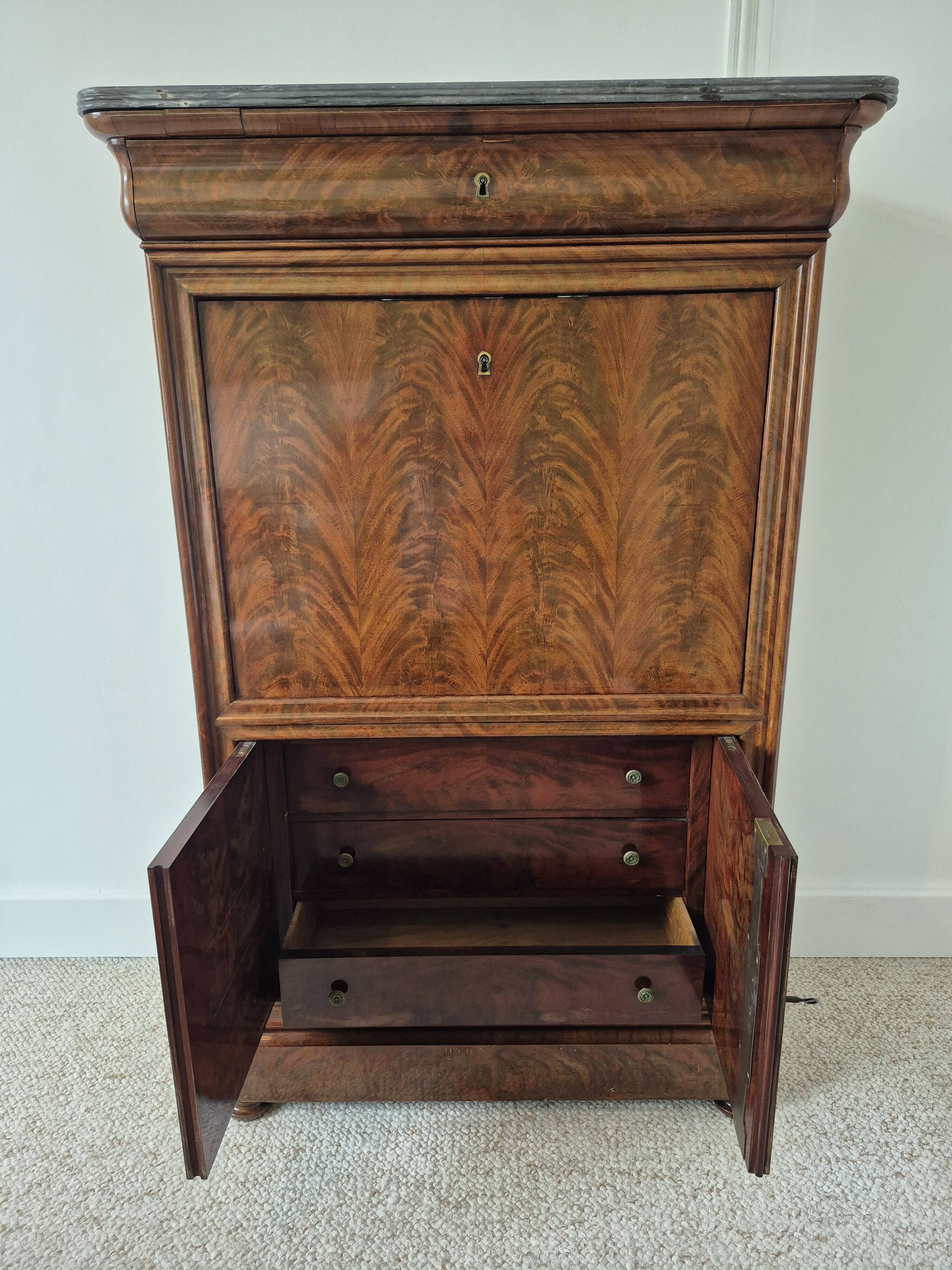 Mahogany secretary desk with marble top and interior mirror.