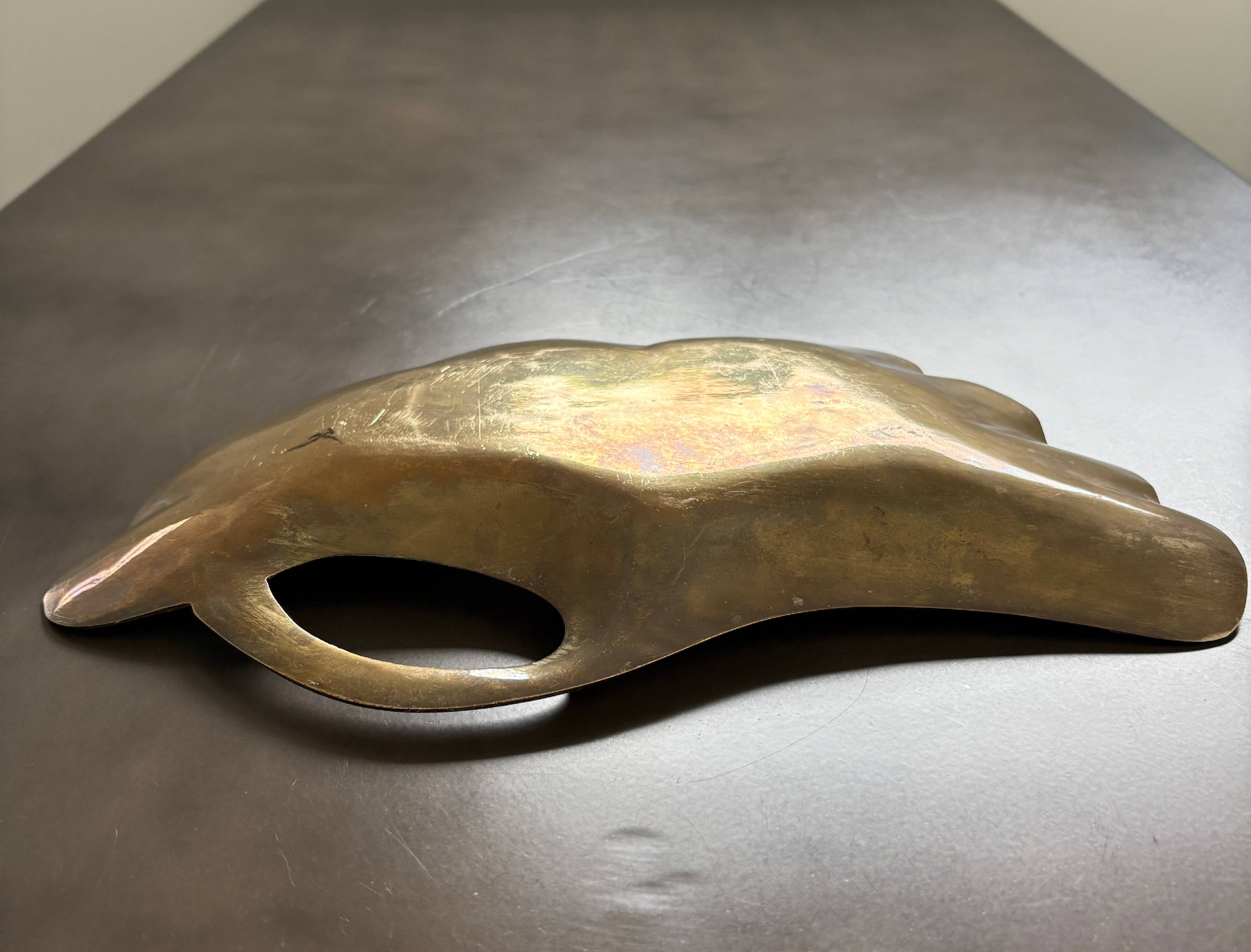 Old brass pocket emptier