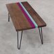 Solid oak coffee table with colored bands on pin legs
