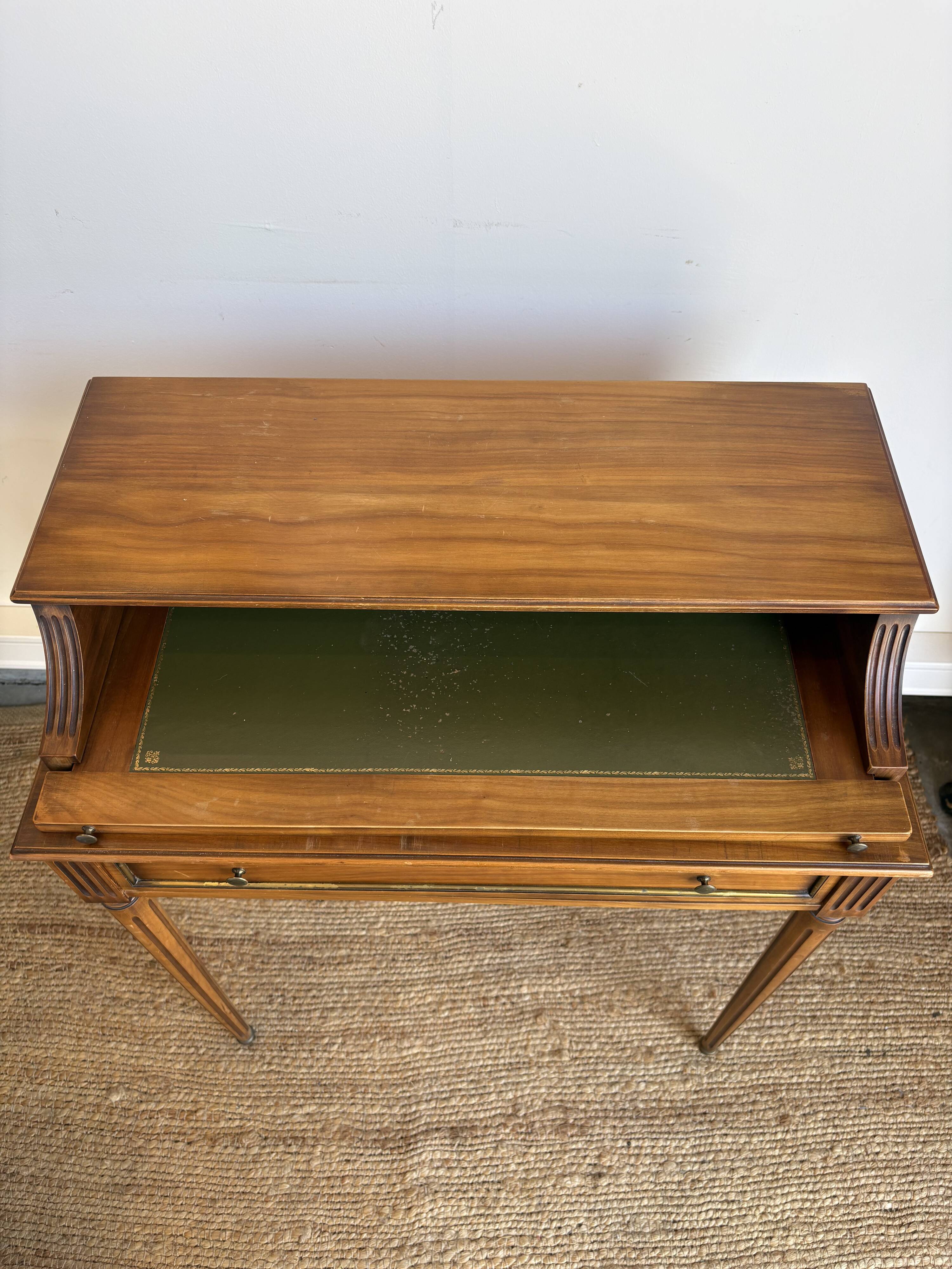 Louis XVI style mahogany telephone table with a green leather top.